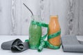 Seasonal Matcha green vegan smoothie and pumpkin carrot smoothie drink detox Breakfast with measuring tape and rubber Royalty Free Stock Photo