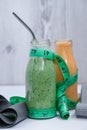 Seasonal Matcha green vegan smoothie and pumpkin carrot smoothie drink detox Breakfast with measuring tape and rubber Royalty Free Stock Photo