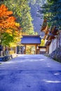 Seasonal Red Maples in Front of The Traditional Temple Entrance Gates on Sacred Mount Koyasan in Japan