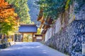 Seasonal Red Maples in Front of The Traditional Temple Entrance Gates on Sacred Mount Koyasan in Japan