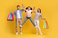 Seasonal Sales Concept. Happy Family Of Three Jumping With Shopping Bags Royalty Free Stock Photo