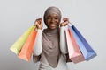 Seasonal Sales. Excited black woman in hijab holding lots of shopping bags