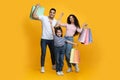 Seasonal Sales. Portrait Of Excited Arab Family Of Three Carrying Shopping Bags Royalty Free Stock Photo