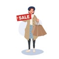 Seasonal Shopping Spree. Autumn Sale. Full-Length Stylish Woman Holding Sale Sign with Shopping Bags. Happy Shopper with Autumn