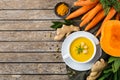 Seasonal spicy fall autumn creamy pumpkin and carrot soup Royalty Free Stock Photo