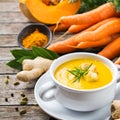 Seasonal spicy fall autumn creamy pumpkin and carrot soup Royalty Free Stock Photo