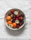 Seasonal summer berries and fruits - apricots, strawberries, cherries in a bowl on a light background, top view Royalty Free Stock Photo
