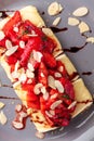 Toast with brie cheese, strawberries and almond flakes