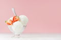 Seasonal sweet dairy dessert - creamy ice cream scoops in elegant bowl with silver spoon, strawberry slice in modern stylish.