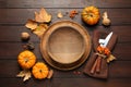 Seasonal table setting with pumpkins and autumn leaves on wooden background, flat lay. Thanksgiving Day Royalty Free Stock Photo