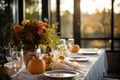 Seasonal table setting with pumpkins and flowers