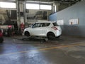 Seasonal tire swapping, from winter to summer tires due to change in seasons and warmer weather. Car lifted and tires removed,