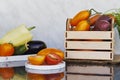 Seasonal vegetables in wooden box and on podiums - fresh tomatoes, purple potatoes, eggplants, carrots, cucumbers, sweet Royalty Free Stock Photo