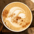 Seasonal warm cinnamon pumpkin spice Latte in eco-cup, top view, close-up