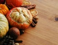 Seasonal wooden table setting with small pumpkins Royalty Free Stock Photo