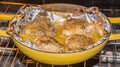 Seasoned Baked Chicken Thighs in Yellow Dutch Oven Royalty Free Stock Photo
