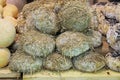 Seasoned cheese covered with straw after aging in a cave