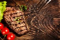 Seasoned grilled tender beef steak on rustic wood