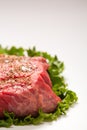 Seasoned Raw Beef On Green Leaf Lettuce with Copy Space Royalty Free Stock Photo