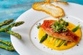 Seasoned roasted green asparagus with grilled salmon on polenta