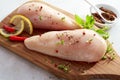 Seasoned skinless raw chicken breasts on a board Royalty Free Stock Photo
