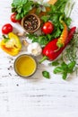 Seasoning background. Fresh and dry herbs, spices, olive oil and vegetables on a wooden table. Top view flat lay background. Copy Royalty Free Stock Photo
