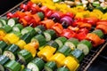seasoning colorful vegetable kabobs before grilling Royalty Free Stock Photo