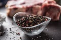 Seasoning four kinds of pepper peas in bowl with raw meat and herbs