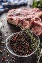 Seasoning four kinds of pepper peas in bowl with raw meat and herbs