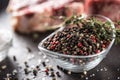 Seasoning four kinds of pepper peas in bowl with raw meat and herbs