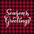 Seasons Greetings calligraphy hand lettering on red buffalo plaid background. Christmas and New Year typography poster Royalty Free Stock Photo