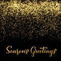 Seasons Greetings calligraphy hand lettering on shiny gold sparkles background. Merry Christmas and Happy New Year Royalty Free Stock Photo