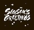 Seasons greetings calligraphy lettering text on black background with vintage paper texture. Retro greeting card for Christmas and Royalty Free Stock Photo