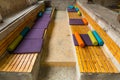 Seat made of wooden blocks and with multi-colored pillows of different shapes Royalty Free Stock Photo