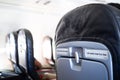 seat rows in an airplane cabin, Interior of commercial airplane with unrecognizable passengers on their seats during flight shot Royalty Free Stock Photo