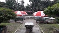 Seat under the umbrellas and view the pond.