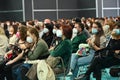 Seated audience wearing protective masks respecting new rules