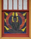 Seated Buddha stained glass window outside the Cosmic Cafe on Oak Lawn in Dallas, Texas.