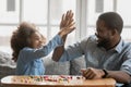 African daughter gives high five to father starting pastime activity Royalty Free Stock Photo