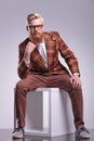 Seated fashion man with beard and glasses Royalty Free Stock Photo