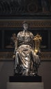Seated female statue made from silver, bronze and gold