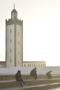 Seated figures near the mosque in Moulay Bousselham, Morocco