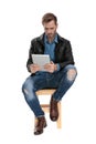 Seated man holding a tablet scared