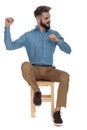 Seated man showing his power while looking away Royalty Free Stock Photo