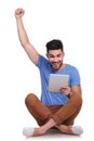Seated man with tablet pad celebrating success Royalty Free Stock Photo