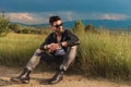 Seated man wearing leather jacket looks away to side Royalty Free Stock Photo