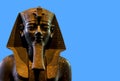 Seated statue of Amenhotep III on blue background Royalty Free Stock Photo