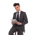 Seated young business man holding tablet Royalty Free Stock Photo