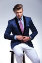 Seated young business man taking his jacket off Royalty Free Stock Photo