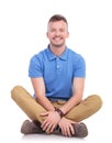 Seated young casual man smiles at camera Royalty Free Stock Photo